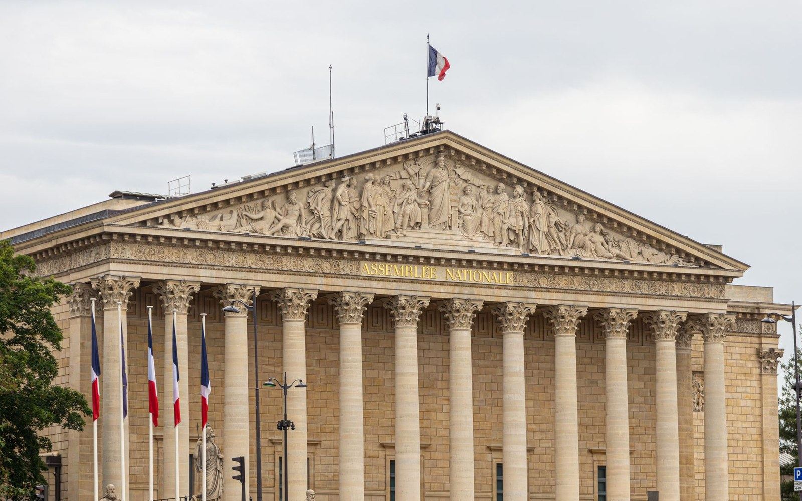 The Assemblée Nationale building with columned facade and French flags flying above