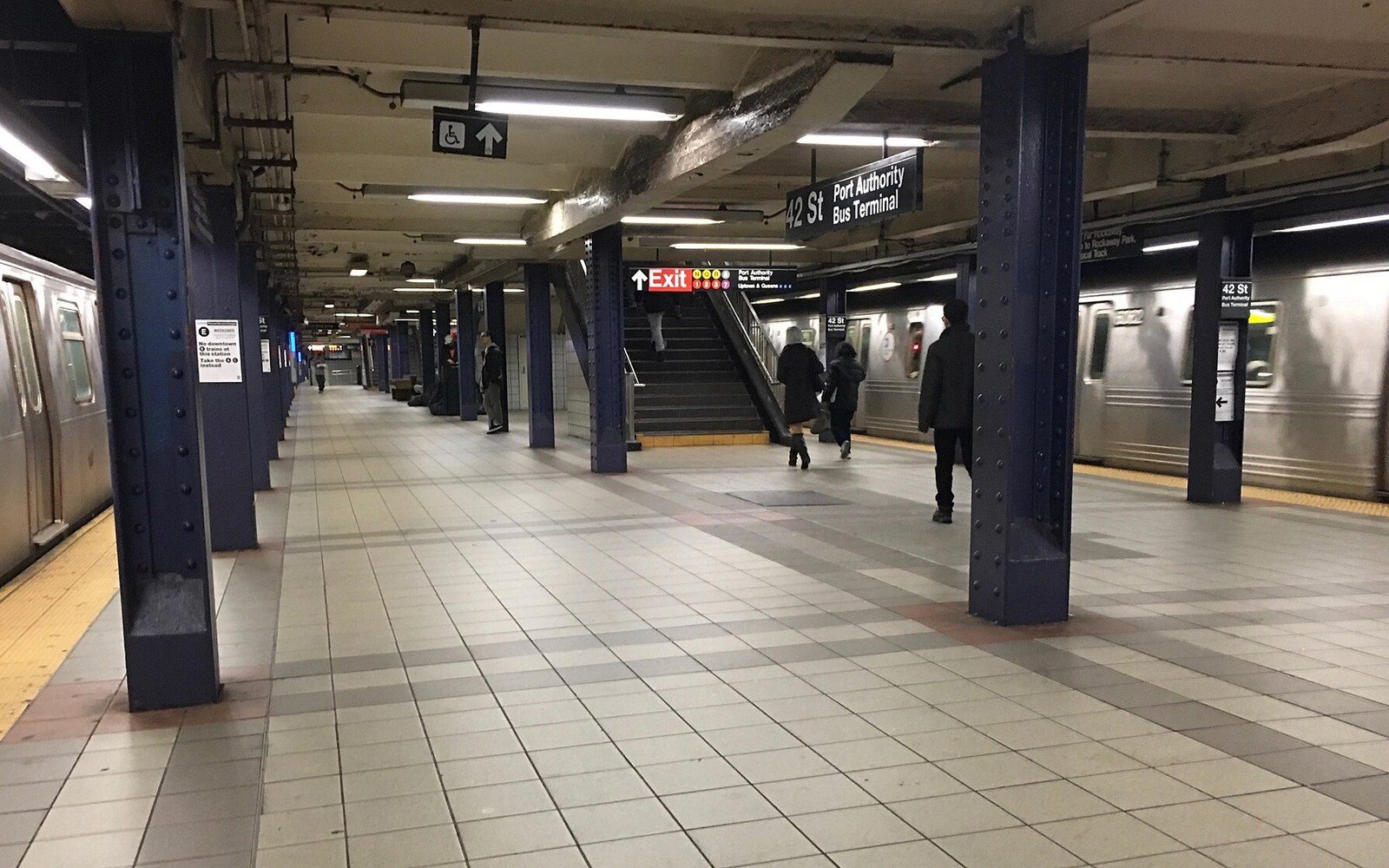 Passengers walk along the 42nd Street subway platform between trains at Port Authority